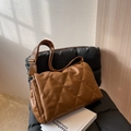 Brown quilted shoulder bag with adjustable wide strap and elegant gold metal buckle - Coffee