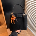 Retro black matte bucket bag with bead pendant and golden metal hardware detail - Black