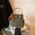Olive green bucket bag in pebble leather with stylish beaded charm and shoulder strap - Green