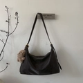 Detail view of dark grey matte leather tote bag with a brown teddy bear charm accessory - Ebony with Pendant