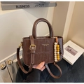 Close-up of vintage dark brown crocodile pattern handbag with wooden bead accessory - Brown (With Pendant)