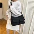Minimalist black nylon crossbody bag with dual front pockets and adjustable strap - Black