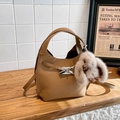 Brown lychee leather bucket bag with cross straps and white plush bunny charm - Biscuit With Charm