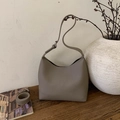 Taupe pebbled leather bucket bag featuring adjustable wide shoulder and crossbody straps - Gray