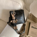 Detail of black pebbled leather bag with ethnic strap and a cute brown rabbit charm - Black with Pendant