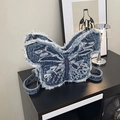 Deep blue denim butterfly backpack featuring frayed edges and adjustable straps - Blue