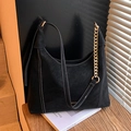 Black suede hobo bag featuring contrast stitching and a chunky gold chain strap - Black