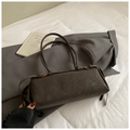 Detail of dark gray suede handbag with golden metal hardware on a gray blazer - Large / Brown