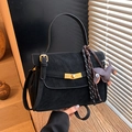 Elegant black matte leather shoulder bag with gold hardware and a cute dog charm accent - Black with Pendant