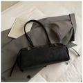 Detail of black suede shoulder bag with golden buckle and textured finish on a blazer - Large / Black
