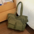 Dettaglio della borsa tote in velluto a coste verde oliva con tasche multiple e patta - Verde