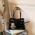 Minimalist black crinkle faux leather tote bag with a bear charm on a silver suitcase - With Charm / Black