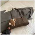 Detailed close-up of dark brown suede shoulder bag with bear pendant and logo - Coffee With Pendant