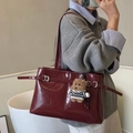 Deep burgundy tote bag in glossy leather with decorative straps and a cute bear charm - With Charm / Burgundy