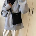 Borsa a secchiello in maglia nera con fibbia in metallo mostrata in stile lifestyle - Nero