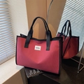 Red checkered tote bag with white grid pattern and black straps for daily commuting - Red