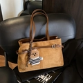 Brown faux suede tote bag with leather straps and bear charm on a black chair - With Charm / Suede Brown