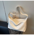 Detail of minimalist beige PU leather tote bag showing soft texture and metal buckle - White