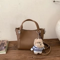 Détail du sac seau en cuir marron avec un adorable porte-clé en peluche chien - Marron (Avec Pendentif)