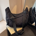Black quilted crossbody dumpling bag with adjustable wide strap and lattice stitching - Black