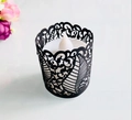 Close-up of laser-cut black hollow pattern lampshade with warm LED tea light - Black