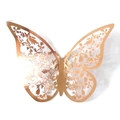 Macro detail of laser-cut rose gold butterfly wall sticker with hollow flower pattern - Rose (BK-181)