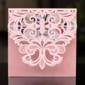Macro detail of laser-cut floral patterns on pink pearlescent paper invitation cover - Pink