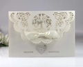 Laser cut pearl white wedding invitation card with elegant satin bow decoration - Ivory