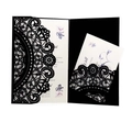 Macro detail of laser-cut black lace wedding invitation with floral printed insert card - Black
