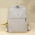 Detailed macro view of the cream-white litchi grain leather texture and rabbit logo - White