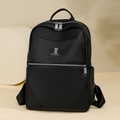 Detailed view of black lychee grain leather texture and silver bunny logo on the backpack - Black