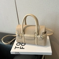Elegant sand beige pebbled leather bowling bag with round handles and shoulder strap - Khaki