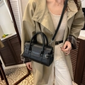 Black lychee leather bowling bag with white stitching and silver hardware - Black