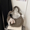 Detail of dark faux leather crescent bag with cloud-pleated strap and bunny charm - Green with Pendant