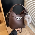 Dark brown bucket bag in pebble leather with a cute white plush rabbit charm - Coffee with Pendant