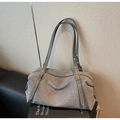 Close-up of gray matte Boston bag featuring golden grommets and slim shoulder straps - Gray