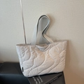 Light gray quilted tote bag with wave stitching and wide handles on leather seat - Gray