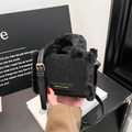 Chic black mini crossbody bag with plush faux fur trim and gold-stamped fashion label - Black