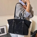 Minimalist black matte leather tote bag with silver eyelets and shoulder straps - Black