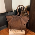 Vintage brown oil wax tote bag with silver buckle straps and minimalist white logo lettering - Brown