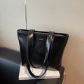 Glossy black faux leather tote bag with zip closure and minimalist brand patch - Black