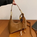 Brown suede crescent moon shoulder bag with gold hardware and tassel detail - With Charm / Brown