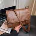 Vintage dark brown crossbody bag with pleated leather texture and buckle straps - Brown