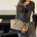 Grey-green leather tote bag with decorative charms shown on model for daily commuting - With Charm / Green