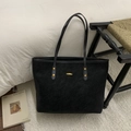 Minimalist black tote bag with gold rivets and handles in a modern home interior - Black without Pendant