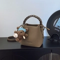 Minimalist large capacity bucket bag in dark khaki leather with a woven handle and bear charm - Elephant Gray with Charm