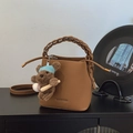 Brown lychee leather bucket bag with woven handle and cute plush bear charm - Brown with Pendant