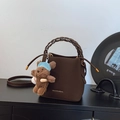 Dark brown leather bucket bag with woven handle and plush bear charm for daily use - Coffee with Pendant