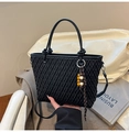Detail of woven lattice texture on a black bucket bag with a colorful beaded charm - Black With Pendant
