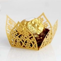 Macro shot of gold laser-cut floral filigree wrapper for chocolate wedding favors - Gold